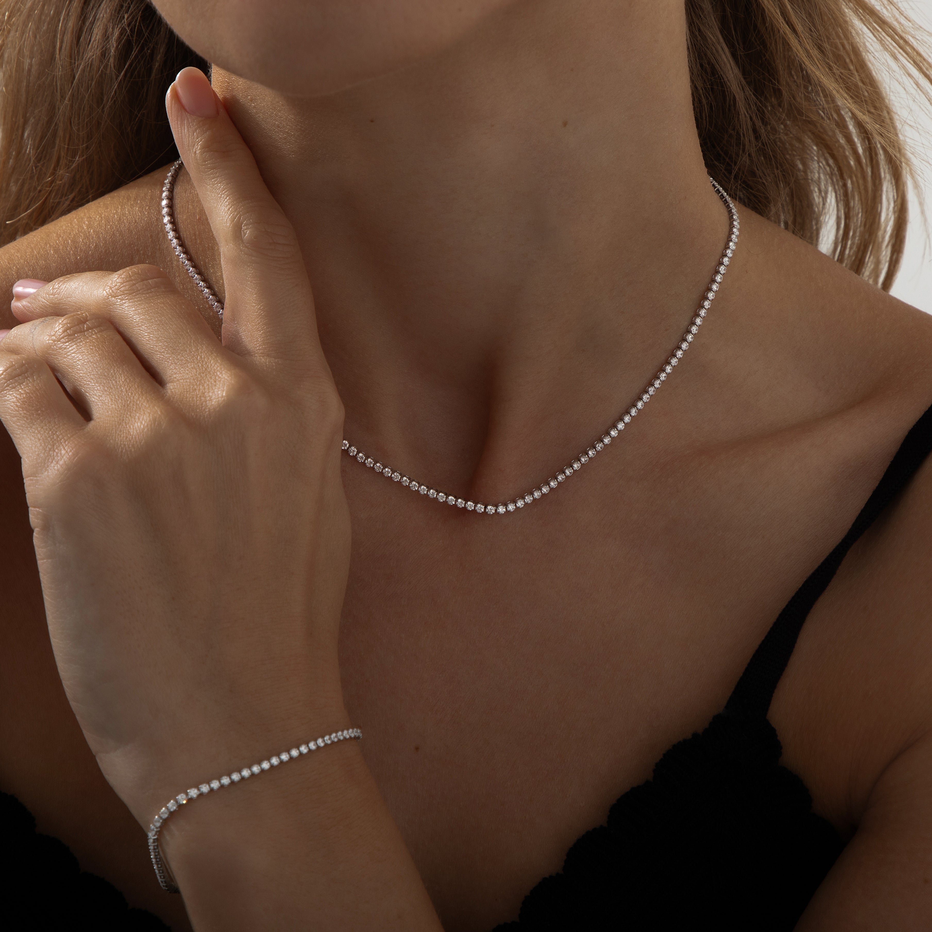 Silver dainty tennis necklace with round-cut cubic zirconia stones on a delicate chain