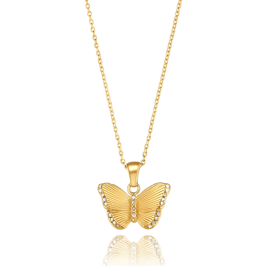 A delicate gold chain holds an ornate butterfly pendant approximately 2 cm wide. The butterfly features intricate filigree wings with openwork lattice and engraved detailing, accented by polished raised areas that catch the light. The body is subtly raised and smooth, with curled antennae. The pendant hangs from a small, plain bail. The chain is a fine, reflective cable‑style with tiny boxed links, fastened via a spring‑ring clasp. Overall, the piece exudes an elegant, vintage-inspired charm, blending airy
