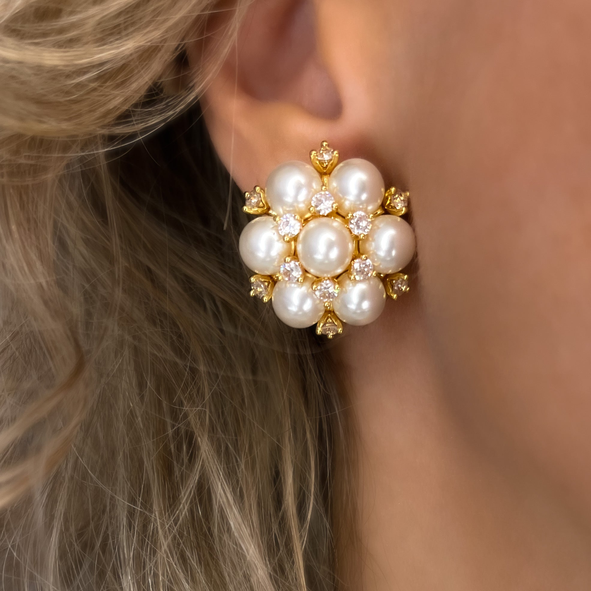 Golden cluster earrings with white pearls and cubic zirconia stones, elegant day-to-night statement jewelry with warm sun-kissed tones.