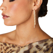 Gold reversible strand earrings, Two-strand gold crystal embellished earrings, Front and back wearable gold earrings, Sleek polished gold earrings with crystal detail, Trendsetting gold earrings as seen on Tess Daly, Modern gold earrings with playful sparkle, Elegant gold earrings with shimmering strands