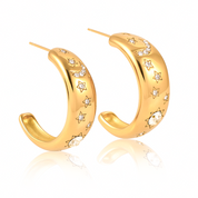 Pair of 18k gold-plated stainless steel hoop earrings, each adorned with a celestial design featuring sparkling stars, a crescent moon, and a radiant sunburst. Delicately inlaid with shimmering AAA cubic zirconia crystals to evoke a night sky effect. Lightweight, waterproof, tarnish-free, and hypoallergenic—crafted for all-day, everyday elegance.