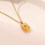 Minimalist gold pendant necklace featuring a rectangular design with a central cubic zirconia stone, inspired by the North Star