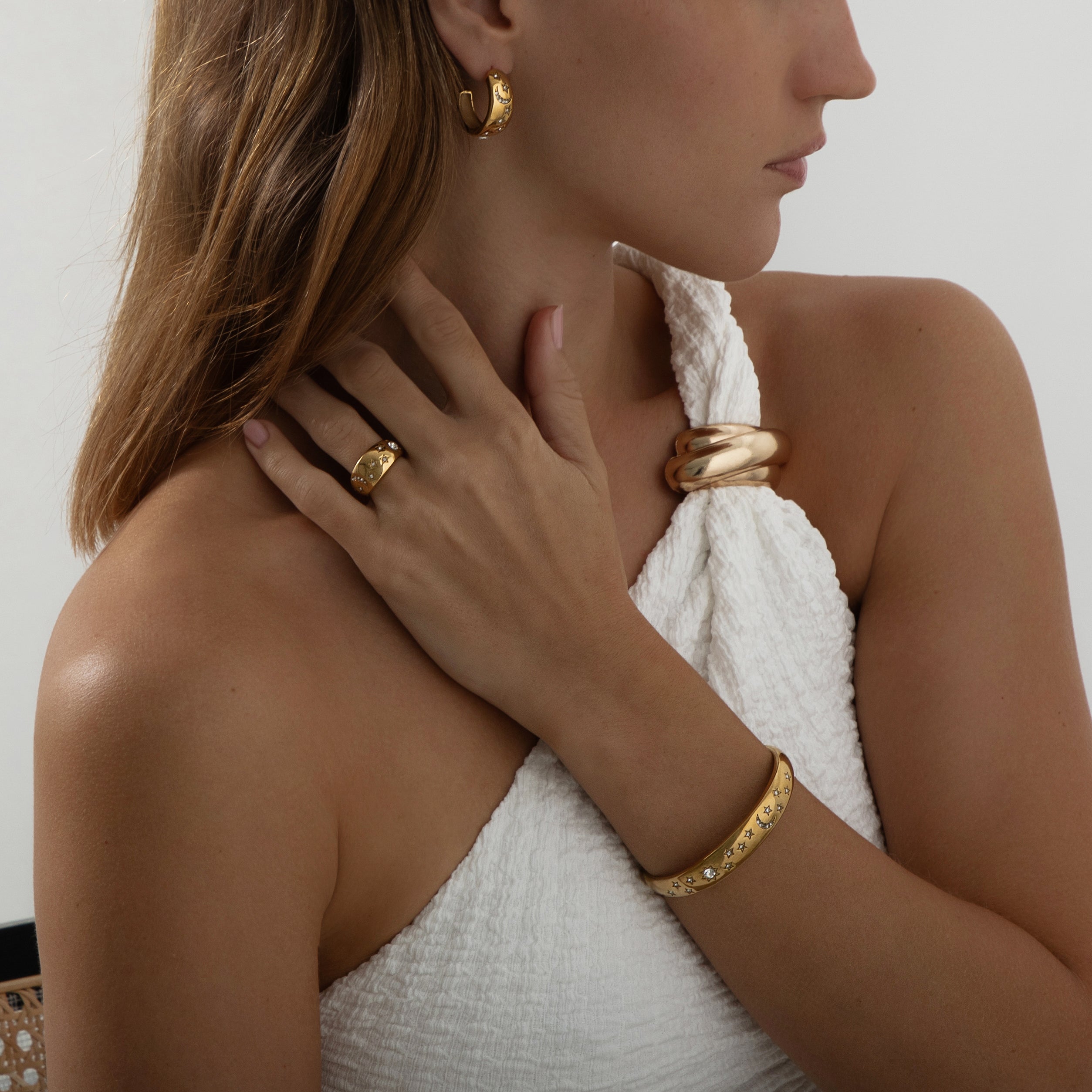 Pair of 18k gold-plated stainless steel hoop earrings, each adorned with a celestial design featuring sparkling stars, a crescent moon, and a radiant sunburst. Delicately inlaid with shimmering AAA cubic zirconia crystals to evoke a night sky effect. Lightweight, waterproof, tarnish-free, and hypoallergenic—crafted for all-day, everyday elegance.