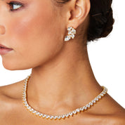 A deluxe tennis-style necklace composed of 7 mm heart-shaped clear cubic zirconia stones, each set in polished 18 ct gold plating. The hearts are aligned closely along a 16‑inch (40 cm) chain, creating a continuous sparkle around the neckline. The design features a secure, invisible clasp hidden behind one stone for a seamless look. The high-reflective gold finish and perfectly cut CZs give the piece a luxurious, radiant appeal—ideal for special occasions or elevating everyday style. It weighs approximately