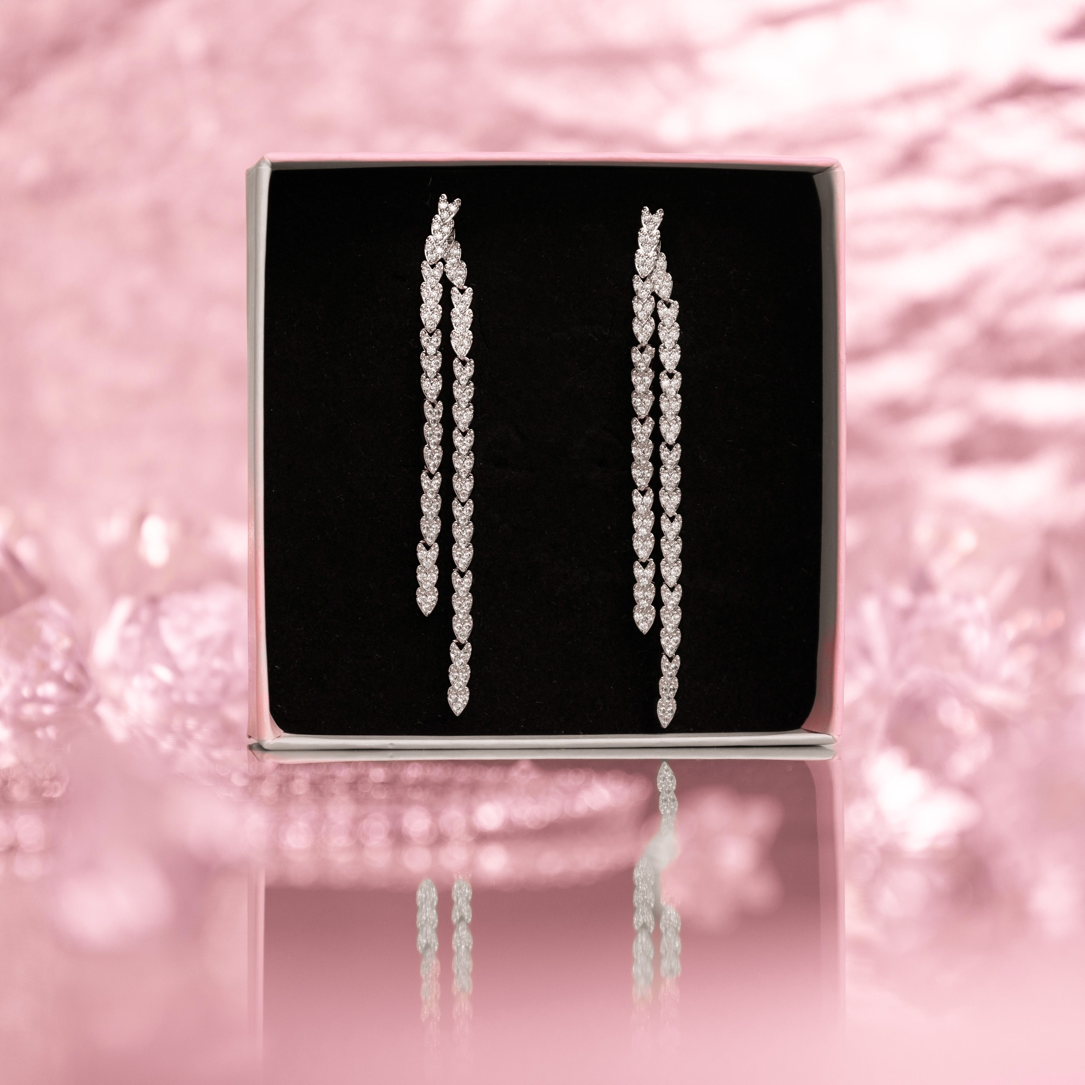 Crystal embellished reversible strand earrings, Long and short crystal strand earrings, Trendsetting front-back earring design, Double strand crystal earrings with sleek finish, As seen on Tess Daly BBC Strictly earrings, Modern reversible crystal shimmer earrings, Playful sparkling crystal earrings