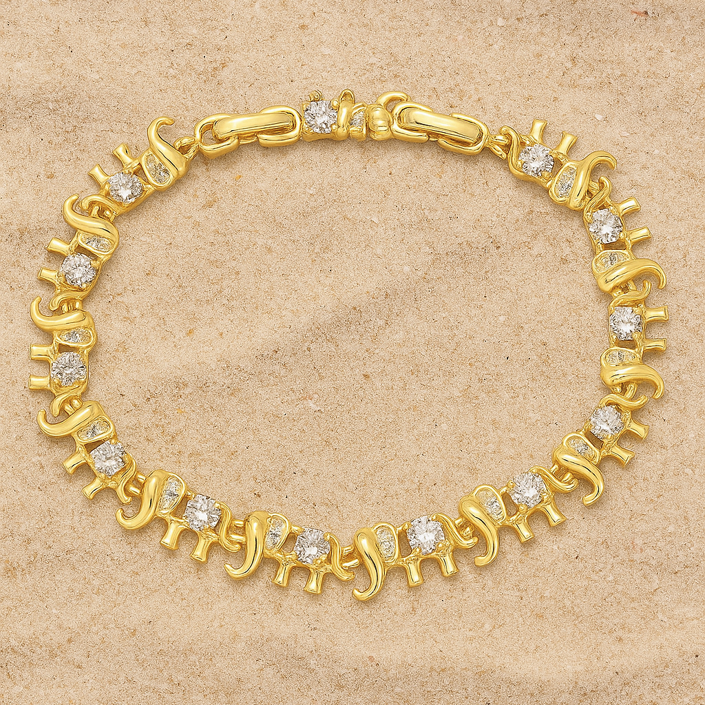 A delicate gold‑plated link bracelet featuring a whimsical parade of stylised elephant silhouettes, each linked trunk-to-tail. The small elephant charms are uniformly sized with softly rounded bodies and upturned trunks, creating a playful, continuous chain. The bracelet is secured with an integrated box‑style clasp and lays flat when worn, measuring around 18 cm in length. The polished gold finish gives a warm, refined sheen, enhancing its charming, artisan-crafted look.