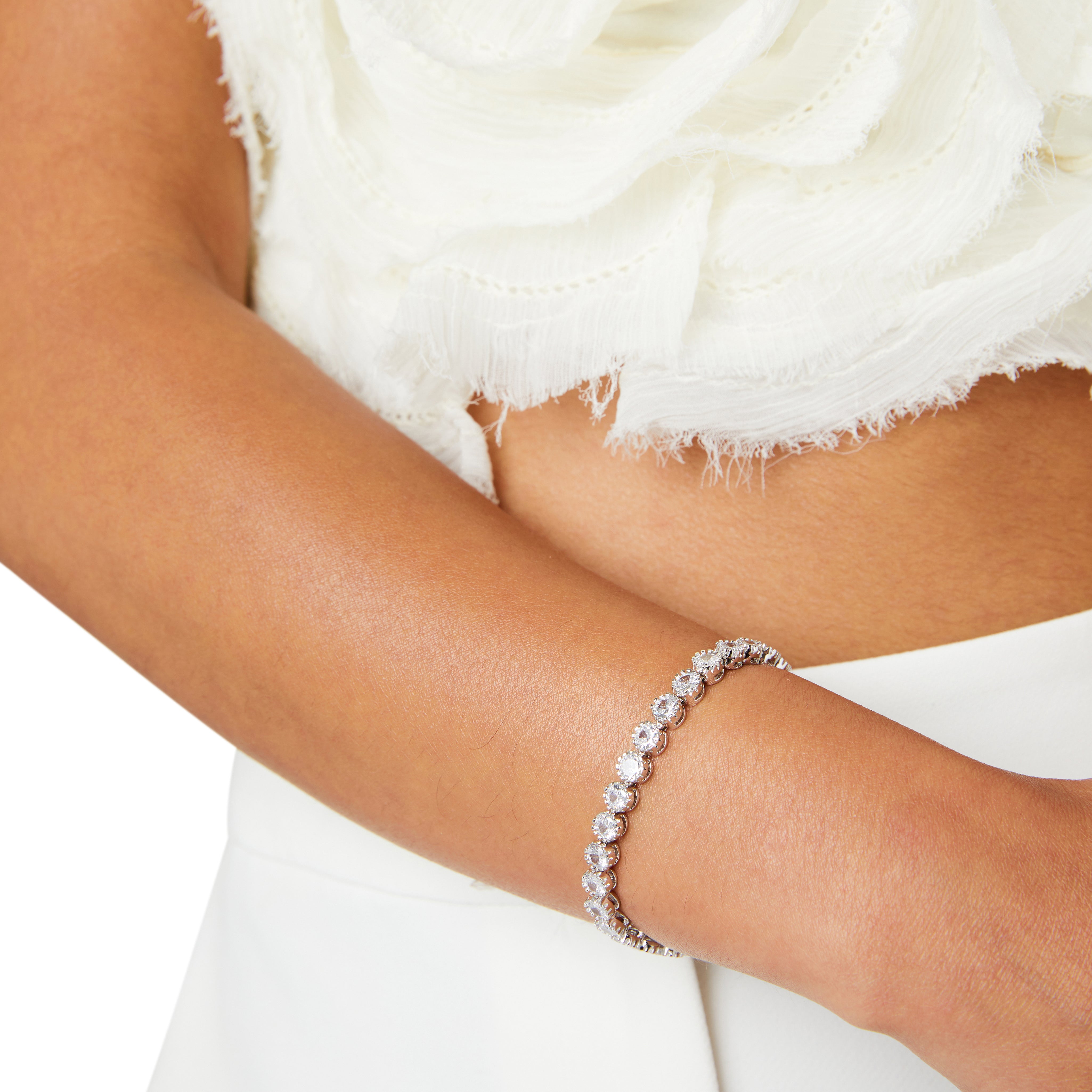 Dainty rhodium-plated tennis bracelet with sparkling 3A cubic zirconia stones in bezel setting, slim 4-5mm width, available in 17cm, 19cm, and 20cm lengths, lightweight and elegant for everyday wear, nickel free, presented in Valentina-Rose gift box.