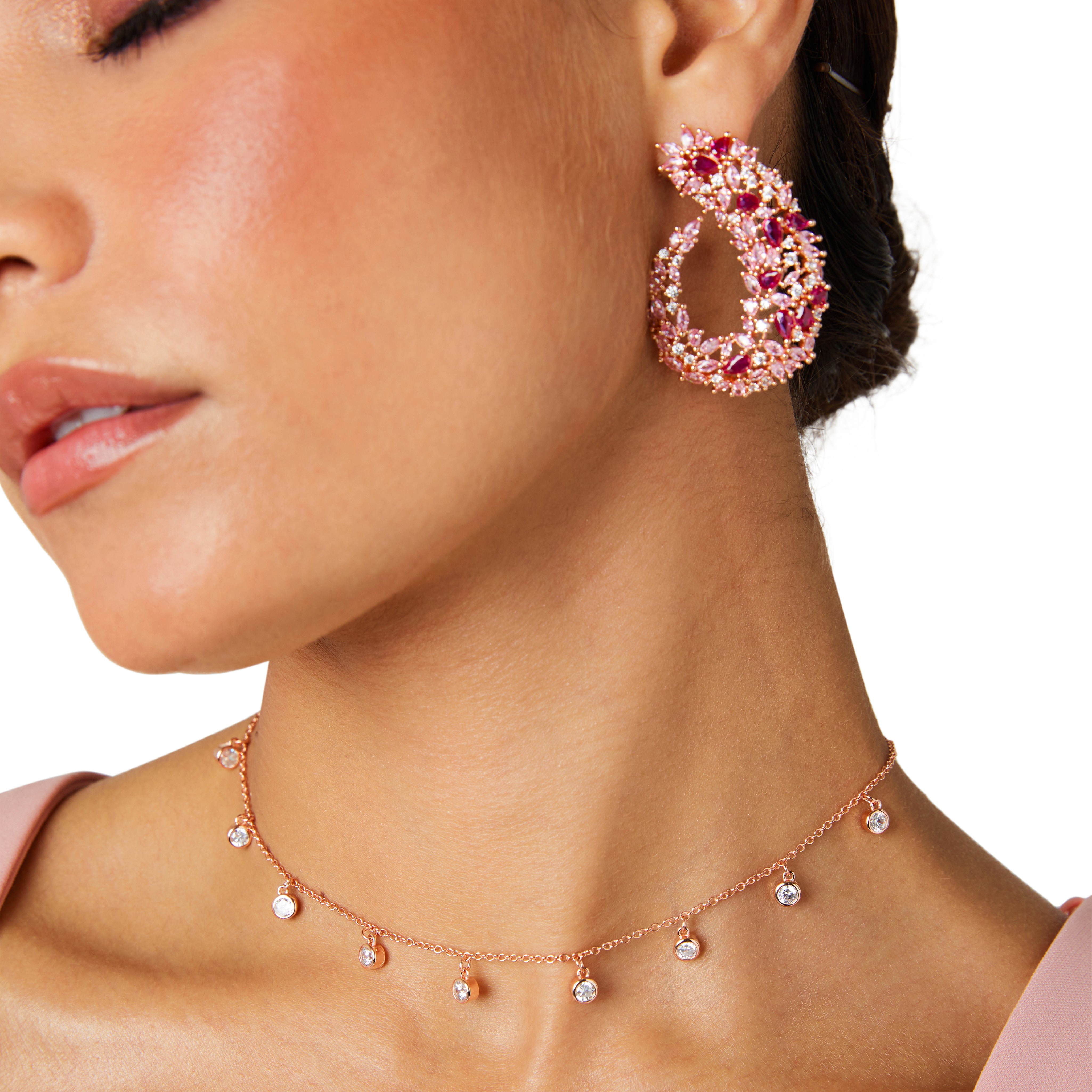 Rose gold drop earrings inspired by Japanese cherry blossoms, featuring marquise pink crystals and a sleek, curvy design for elegant statement style.