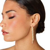 Gold reversible strand earrings, Two-strand gold crystal embellished earrings, Front and back wearable gold earrings, Sleek polished gold earrings with crystal detail, Trendsetting gold earrings as seen on Tess Daly, Modern gold earrings with playful sparkle, Elegant gold earrings with shimmering strands