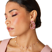 Rose gold drop earrings inspired by Japanese cherry blossoms, featuring marquise pink crystals and a sleek, curvy design for elegant statement style.