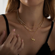 Model wearing the Wild Spirit gold tiger necklace — bold animal silhouette pendant on a delicate chain