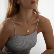 Gold pendant necklace featuring a polished crescent moon charm on a delicate chain, part of the Illuminate Collection by Valentina Rose.