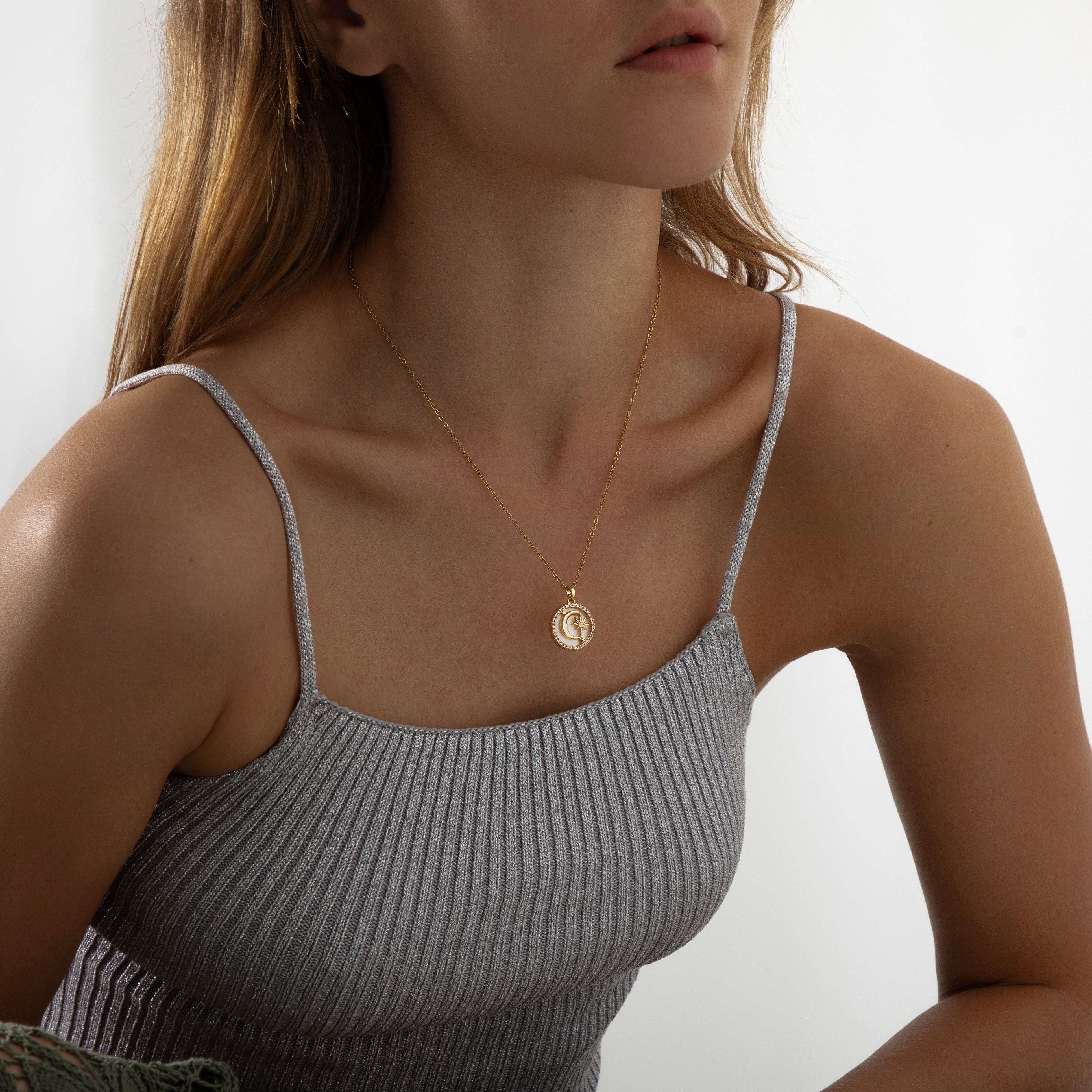 Gold pendant necklace featuring a polished crescent moon charm on a delicate chain, part of the Illuminate Collection by Valentina Rose.
