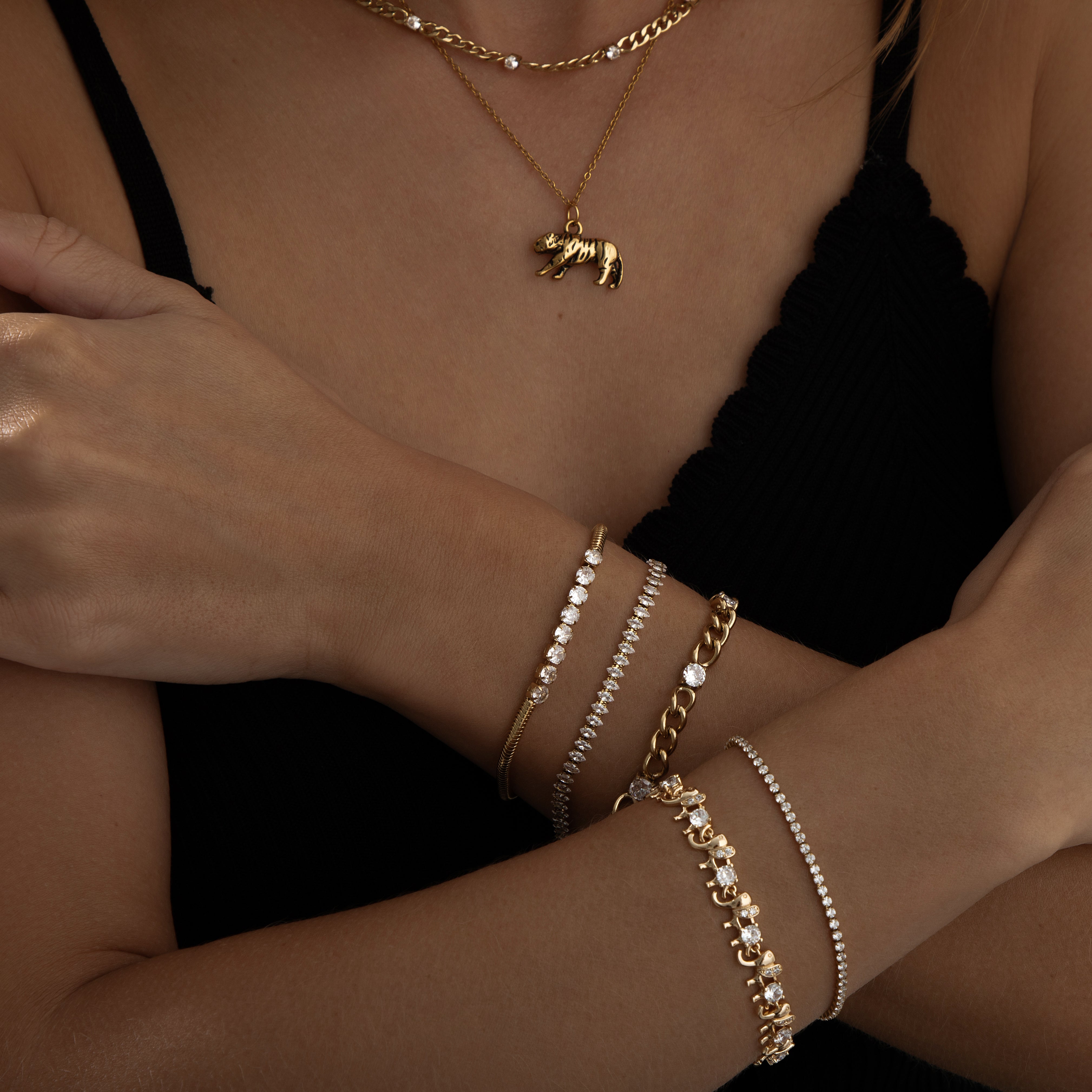 Gold-plated stainless steel chain bracelet with five spaced cubic zirconia crystals, 0.51 cm wide, adjustable length, waterproof and sweatproof elegant jewelry piece.