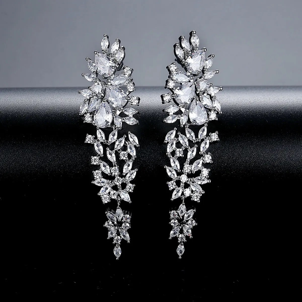 Starlet Supreme earrings, silver drop earrings, long statement earrings, geometric cubic zirconia, sparkling detail, worn by Tess Daly, BBC Strictly Come Dancing, model wearing earrings, evening jewelry, special occasion earrings, elegant design, party earrings, wedding guest jewelry, red carpet style