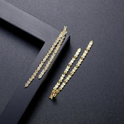 Gold reversible strand earrings, Two-strand gold crystal embellished earrings, Front and back wearable gold earrings, Sleek polished gold earrings with crystal detail, Trendsetting gold earrings as seen on Tess Daly, Modern gold earrings with playful sparkle, Elegant gold earrings with shimmering strands