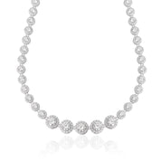Silver crystal tennis necklace with graduated cubic zirconia stones haloed by pavé, rhodium-plated brass, displayed on a clean white background