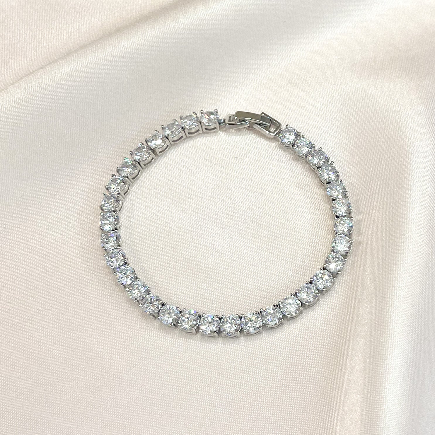 Close-up of silver tennis bracelet with sparkling cubic zirconia stones set in a delicate line
