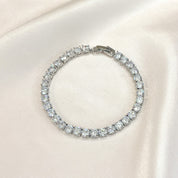 Close-up of silver tennis bracelet with sparkling cubic zirconia stones set in a delicate line