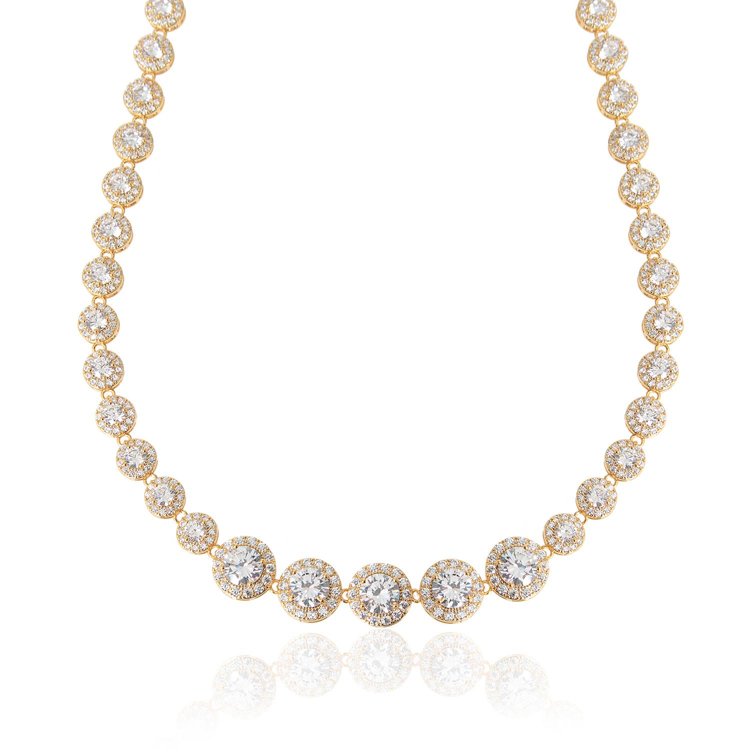 A gold-colored crystal tennis necklace with graduated sizes of clear cubic zirconia stones, presented against a white background.