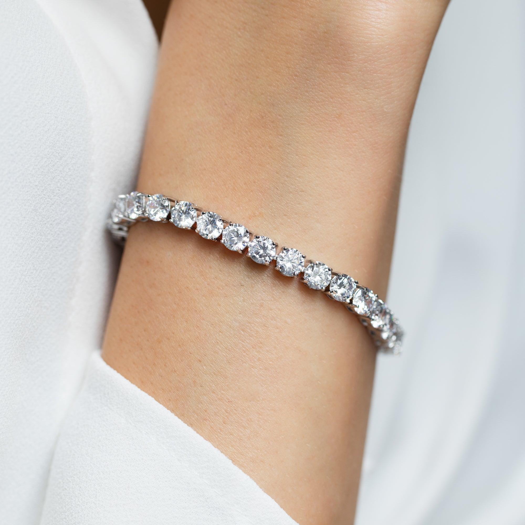 Model wearing silver deluxe tennis bracelet – elegant sparkle adds glamour to evening look