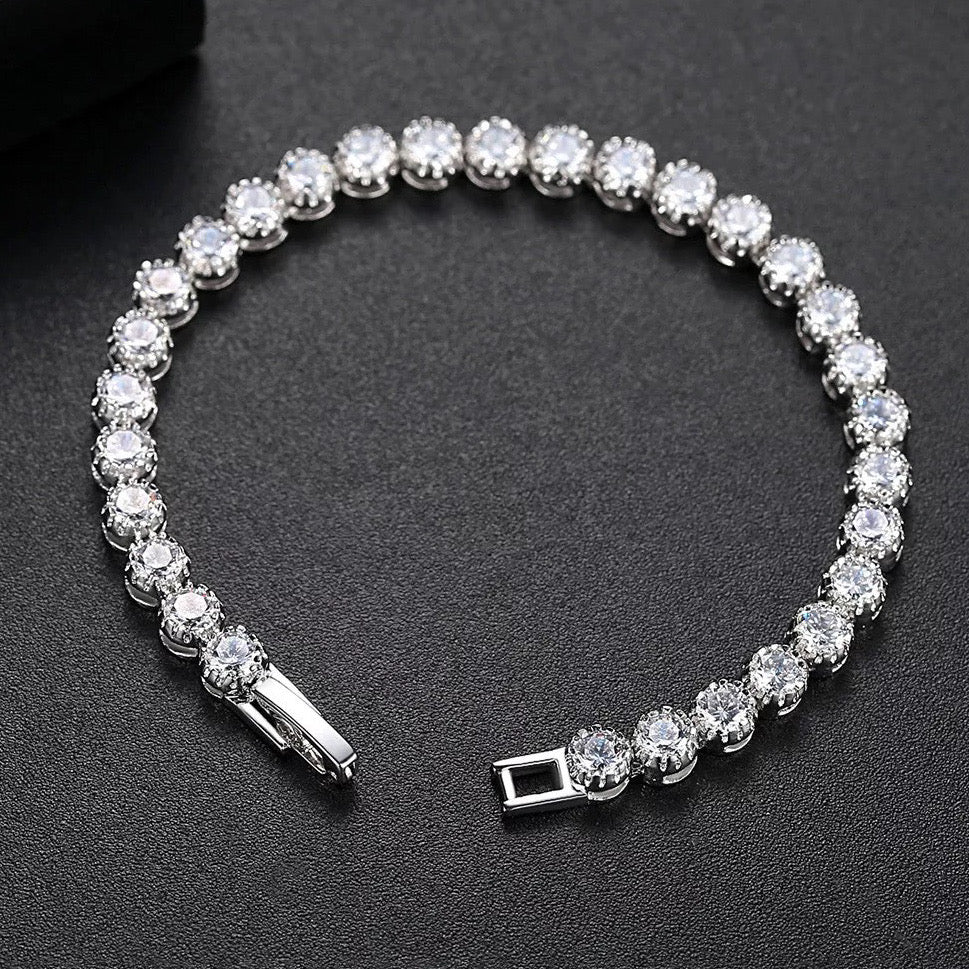 Dainty rhodium-plated tennis bracelet with sparkling 3A cubic zirconia stones in bezel setting, slim 4-5mm width, available in 17cm, 19cm, and 20cm lengths, lightweight and elegant for everyday wear, nickel free, presented in Valentina-Rose gift box.