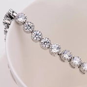 Dainty rhodium-plated tennis bracelet with sparkling 3A cubic zirconia stones in bezel setting, slim 4-5mm width, available in 17cm, 19cm, and 20cm lengths, lightweight and elegant for everyday wear, nickel free, presented in Valentina-Rose gift box.