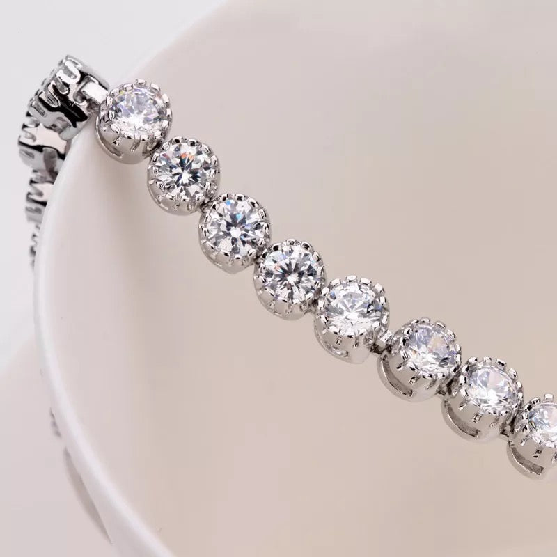 Dainty rhodium-plated tennis bracelet with sparkling 3A cubic zirconia stones in bezel setting, slim 4-5mm width, available in 17cm, 19cm, and 20cm lengths, lightweight and elegant for everyday wear, nickel free, presented in Valentina-Rose gift box.