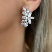 Statement silver cluster earrings featuring shimmering marquise-cut stones, styled on model with light-catching sparkle