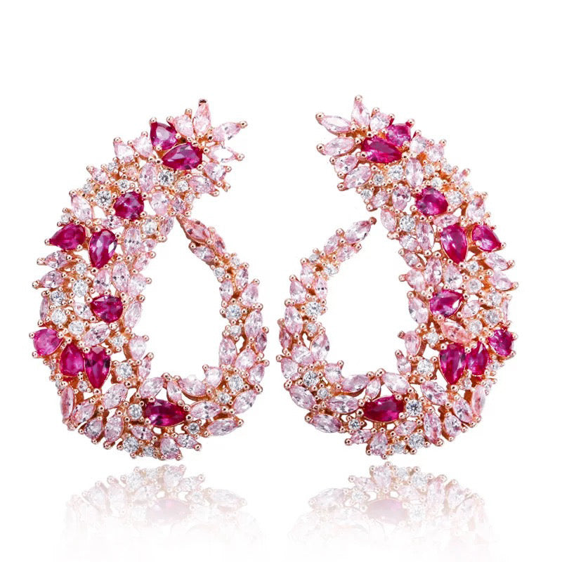 Rose gold drop earrings inspired by Japanese cherry blossoms, featuring marquise pink crystals and a sleek, curvy design for elegant statement style.