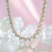 A deluxe tennis-style necklace composed of 7 mm heart-shaped clear cubic zirconia stones, each set in polished 18 ct gold plating. The hearts are aligned closely along a 16‑inch (40 cm) chain, creating a continuous sparkle around the neckline. The design features a secure, invisible clasp hidden behind one stone for a seamless look. The high-reflective gold finish and perfectly cut CZs give the piece a luxurious, radiant appeal—ideal for special occasions or elevating everyday style. It weighs approximately