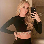 Silver chandelier earrings featuring cascading white cubic zirconia stones, rhodium-plated with a 6.4 cm drop, shown on model and against light and dark backgrounds.