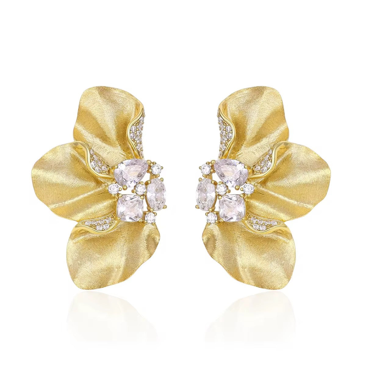 Sculptural Brushed Gold floral petal earrings with zirconia white gemstones on a white background
