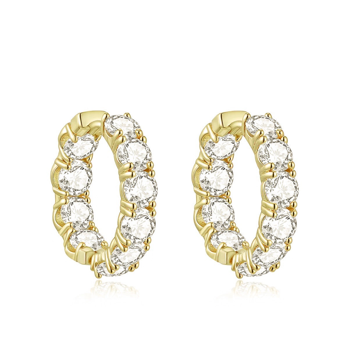 Gold hoop earrings with clear gemstones on a white background
