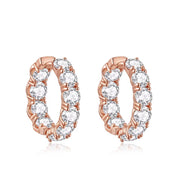 Rose gold hoop earrings with clear gemstones on a white background
