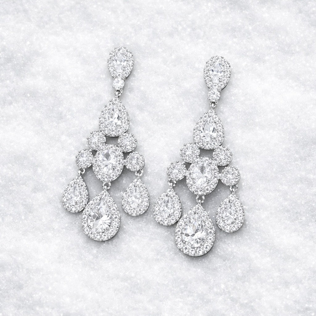 Pair of diamond like chandelier earrings winter background