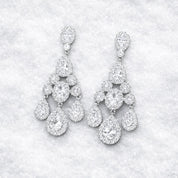 Pair of diamond like chandelier earrings winter background