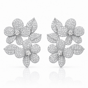 A pair of silver-toned pavé flower stud earrings with leaf details, set with small clear stones and photographed on a clean white background with a soft reflection below.