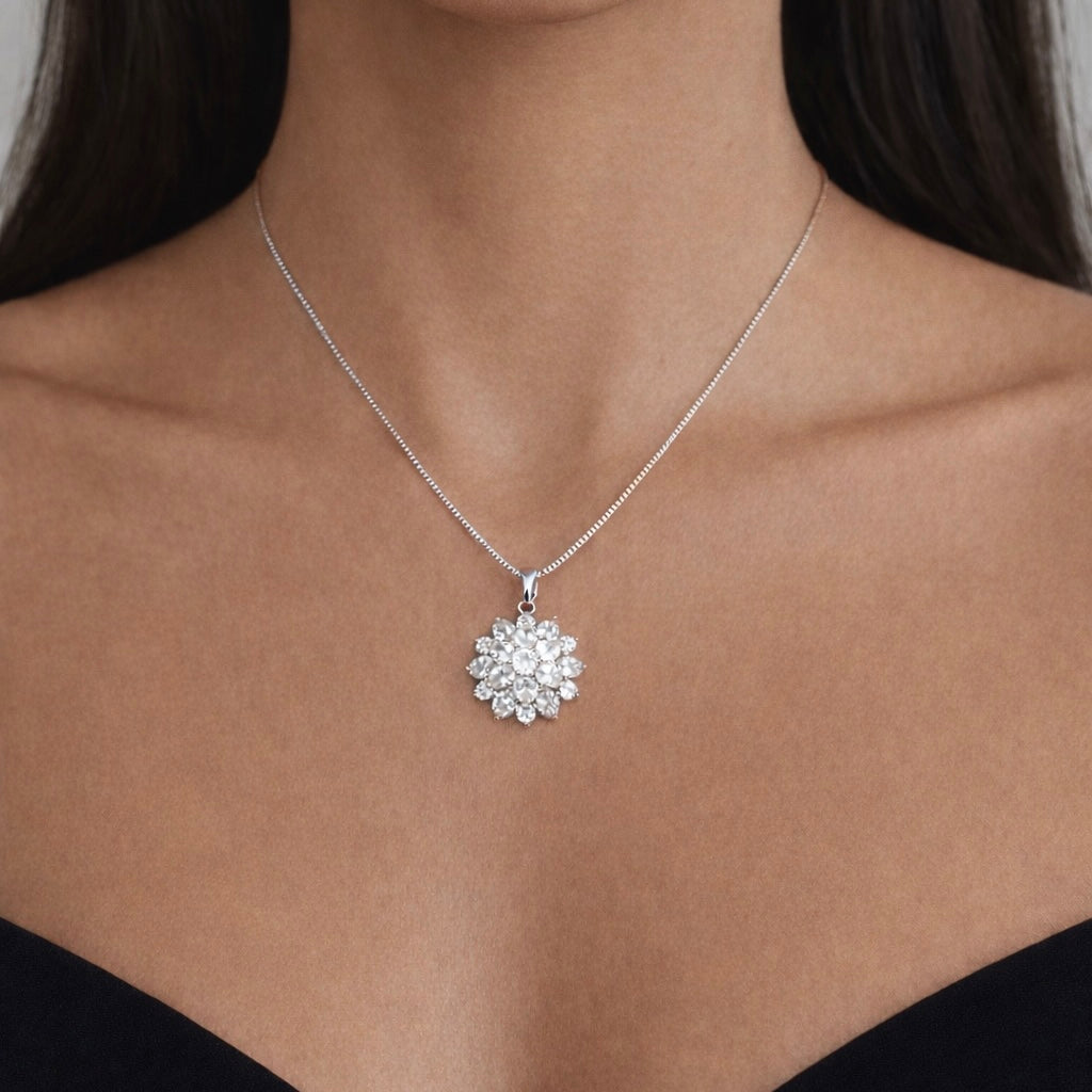 Silver necklace with a floral cluster pendant on a model