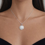 Silver necklace with a floral cluster pendant on a model