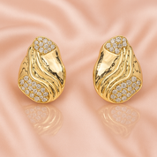 A pair of gold‑plated stud earrings, each shaped like three elegant, tapering wave arches that fan outward in a stylised, goddess-inspired design. The curved strands are smooth, mirror‑polished, and evenly spaced, creating a sense of movement and volume while remaining compact—approximately 1.3 cm tall from post to tip. They appear to sit snugly along the earlobe and fasten with standard push-back posts. The warm metallic sheen and sculptural silhouette evoke a graceful, contemporary luxury vibe.