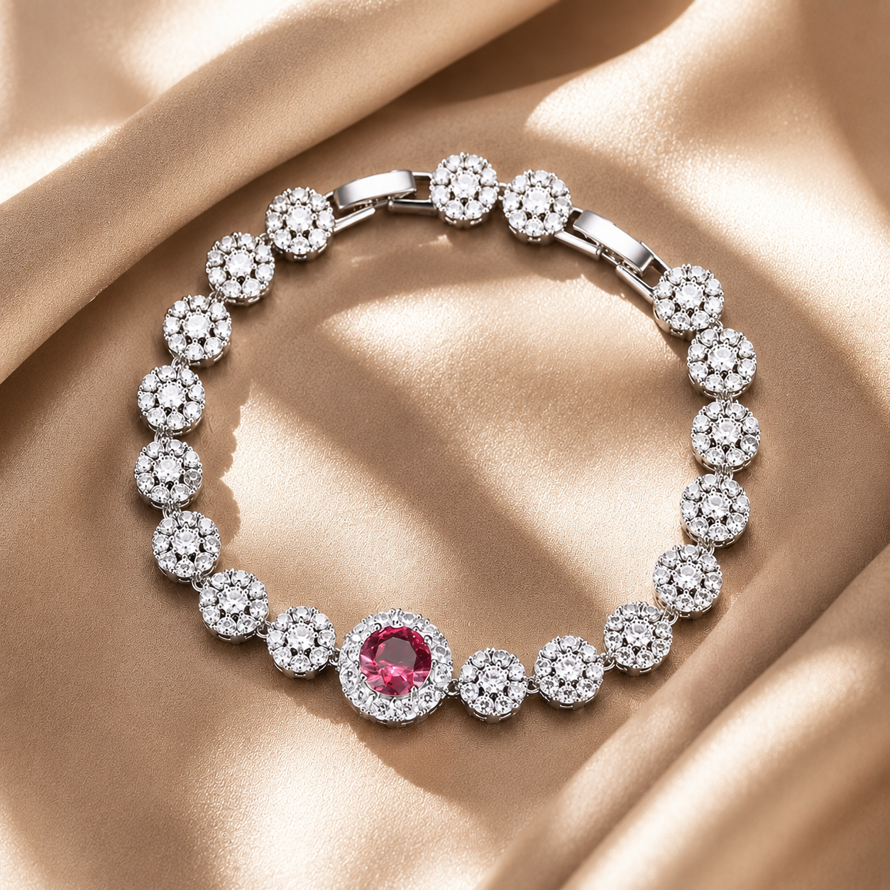 Silver bracelet with a central red gemstone on a beige fabric background