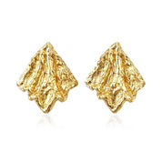 Pair of gold molten earrings on a white background