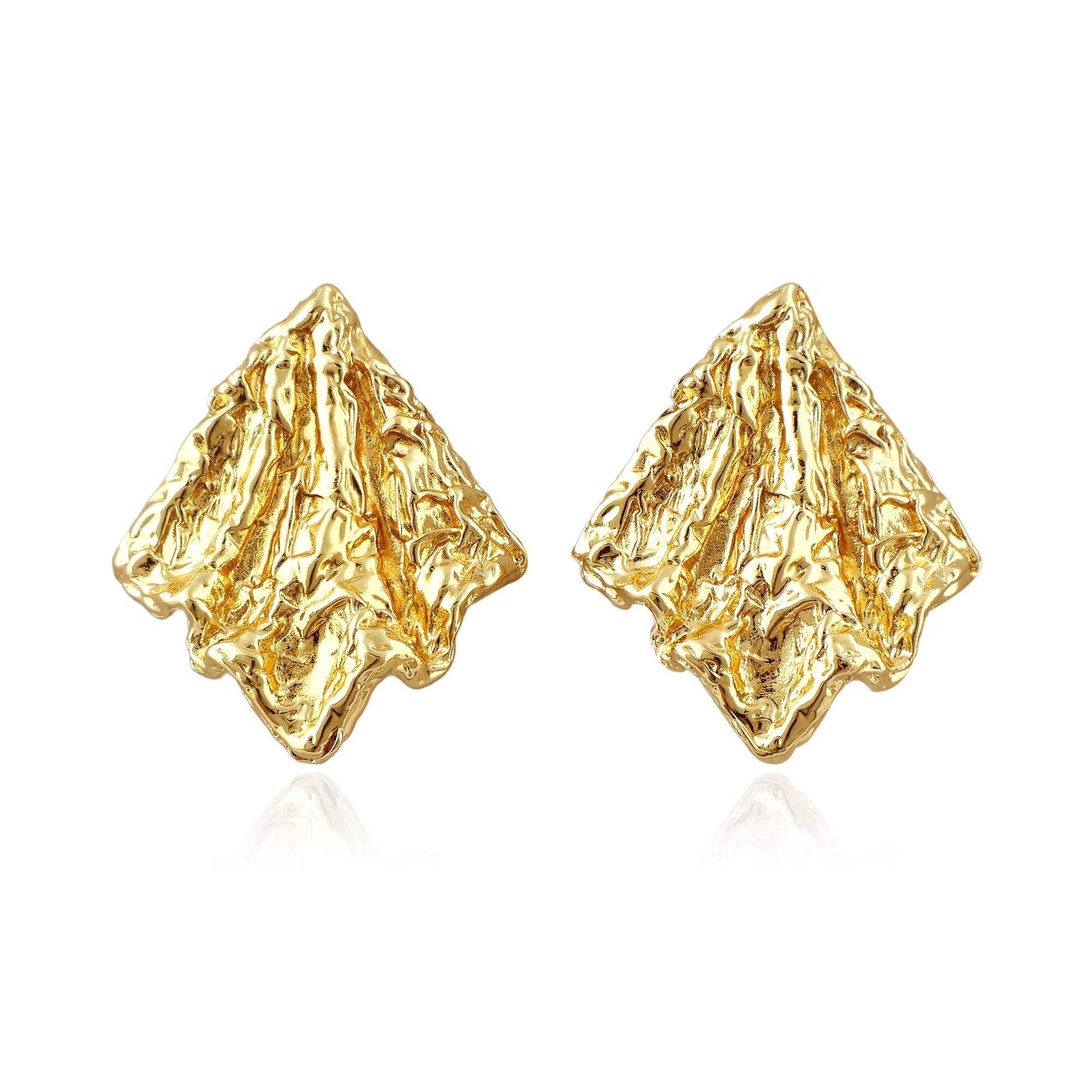 Pair of gold molten earrings on a white background