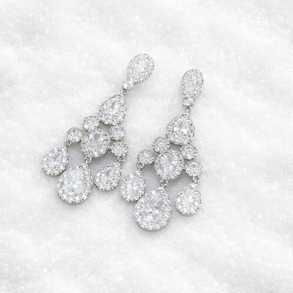 Pair of diamond like earrings on a winter snow background
