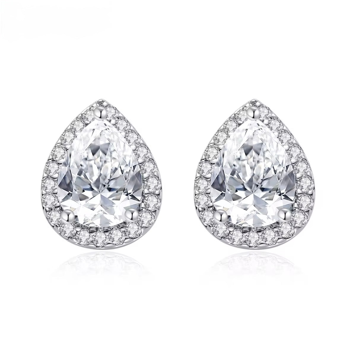 Pair of teardrop-shaped diamond earrings on a white background
