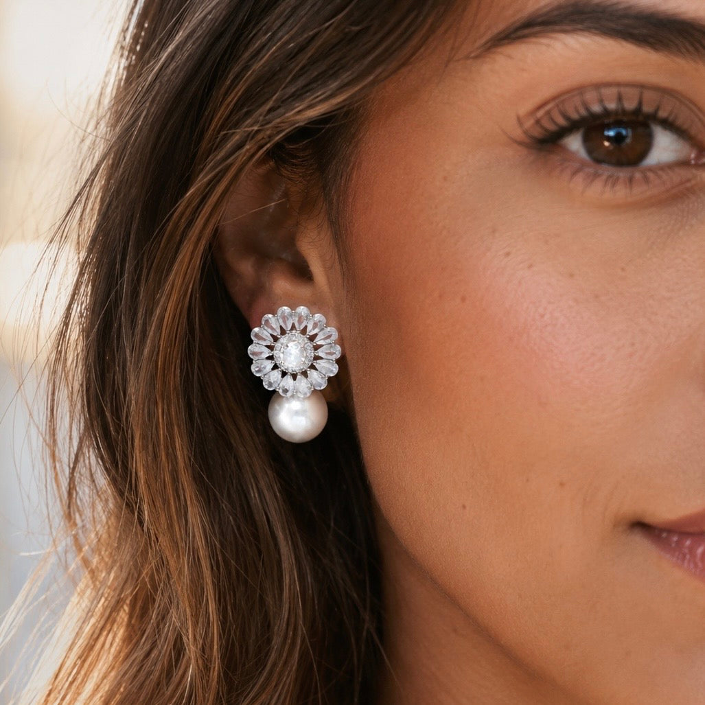 Model wearing a cz floral earring with a pearl detail.