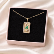 Pisces zodiac Necklace with a pendant in a pink box on a satin surface