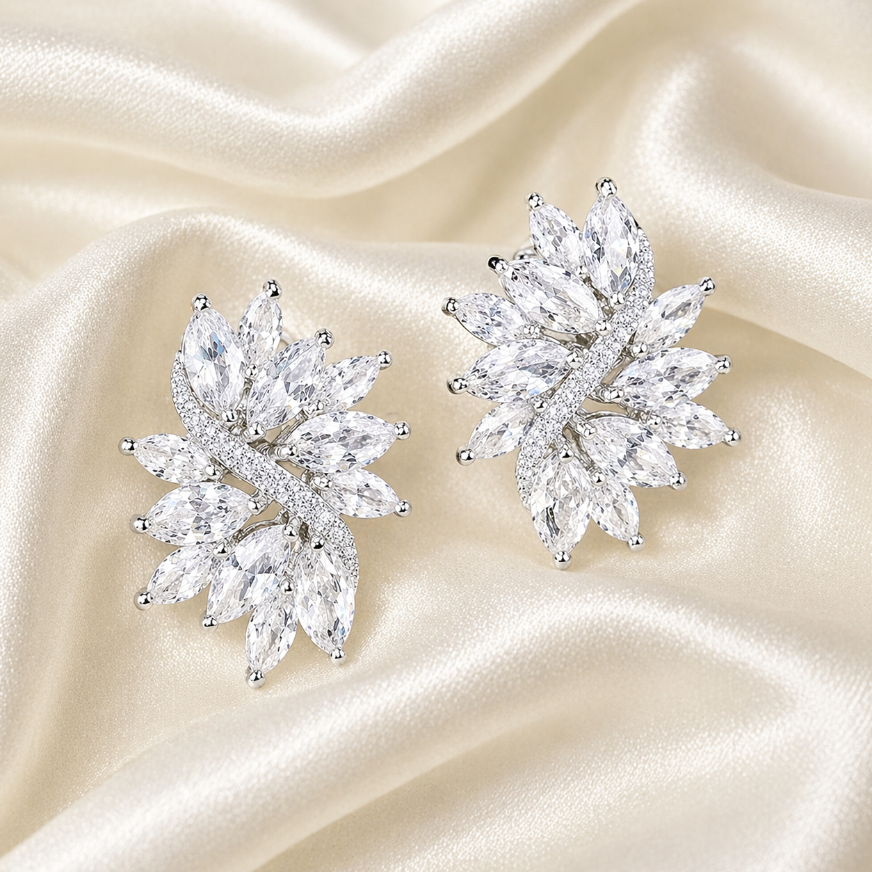 Valentina-Rose crystal cluster stud earrings on ivory silk background, marquise-cut stones with high-shine silver-tone finish, luxury bridal and statement earrings UK