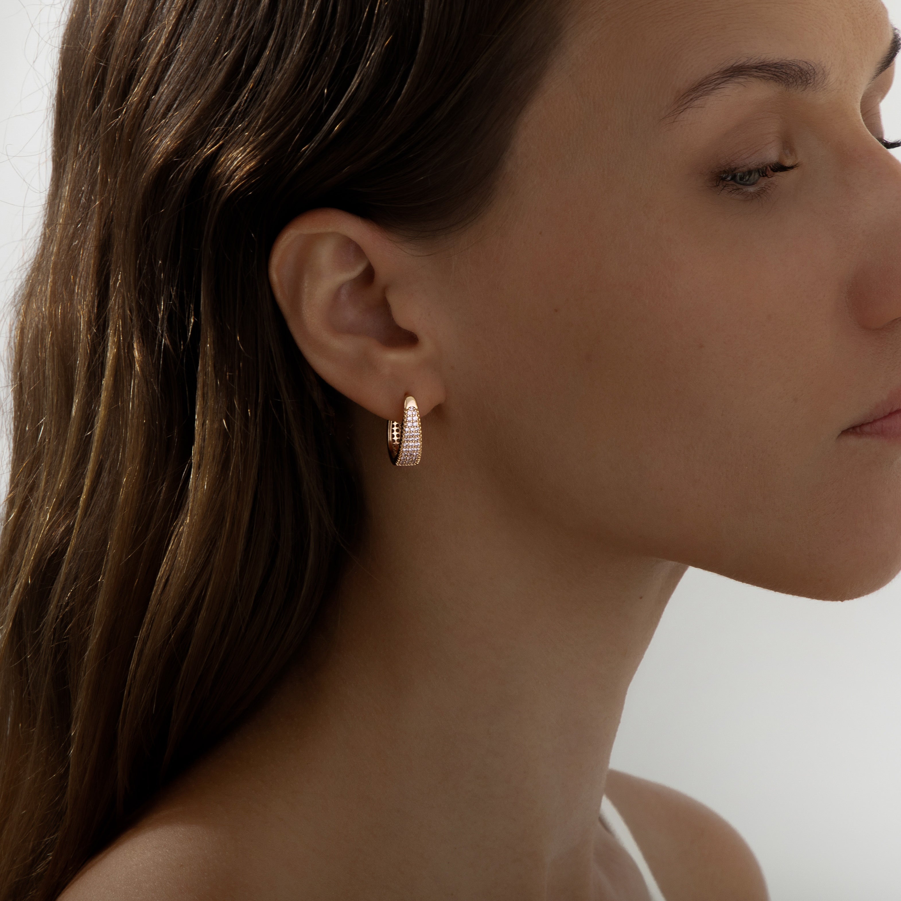 Rose gold huggie hoop earrings with pavé cubic zirconia, gently domed and polished for subtle sparkle. Medium-small size (1.7cm), shown in eco-friendly Valentina Rose gift box.